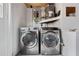 Laundry room with new washer and dryer and grey epoxy floors at 5027 Overton Dr, New Port Richey, FL 34652