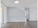 Spacious living room with hardwood floors and neutral paint, complemented by wainscoting and a bright, airy ambiance at 5027 Overton Dr, New Port Richey, FL 34652