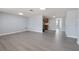 Open living room featuring neutral walls, recessed lighting, and modern gray wood-look flooring at 5027 Overton Dr, New Port Richey, FL 34652