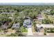 Aerial view of the home surrounded by mature trees and landscaping at 511 Roanoke St, Dunedin, FL 34698