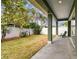 View of the covered back porch overlooking the lawn and landscaping at 511 Roanoke St, Dunedin, FL 34698