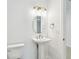 Bathroom featuring a pedestal sink, modern lighting fixtures, and stylish accents at 511 Roanoke St, Dunedin, FL 34698