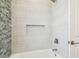 Bathroom with tiled shower and tub at 511 Roanoke St, Dunedin, FL 34698