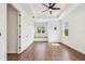 Large bedroom with a window seat, tray ceiling, ceiling fan, hardwood floors, and lots of natural light at 511 Roanoke St, Dunedin, FL 34698