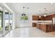 View of the kitchen with an island and dark wood cabinets with a dining space at 511 Roanoke St, Dunedin, FL 34698
