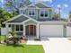 Inviting home with a two-car garage, mature trees, and a freshly painted exterior at 511 Roanoke St, Dunedin, FL 34698