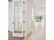 Bright hallway with tiled floors, glass-paned doors, and views to the backyard at 511 Roanoke St, Dunedin, FL 34698
