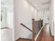 Upstairs hallway with wood flooring and views into adjacent rooms at 511 Roanoke St, Dunedin, FL 34698