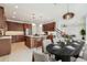 Gourmet kitchen, dining area with table settings, island with bar seating, stainless steel appliances, and dark wood cabinets at 511 Roanoke St, Dunedin, FL 34698