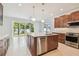 An open kitchen design with a stainless steel dishwasher, view to backyard, and a large island at 511 Roanoke St, Dunedin, FL 34698
