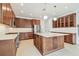 A modern kitchen featuring dark wood cabinets, stainless steel appliances, and a spacious island at 511 Roanoke St, Dunedin, FL 34698