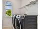 Laundry room with a washer, dryer, and window offering a clean, bright, and efficient space at 511 Roanoke St, Dunedin, FL 34698