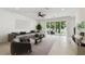 Bright living room with tile floors, neutral color scheme, and large sliding glass doors to the back yard at 511 Roanoke St, Dunedin, FL 34698