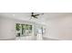 Bright living room with backyard view through sliding glass doors and adjacent staircase at 511 Roanoke St, Dunedin, FL 34698