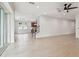Open-concept layout with light tile flooring and access to the backyard through sliding glass doors at 511 Roanoke St, Dunedin, FL 34698