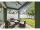 Covered outdoor patio space with outdoor seating overlooking the backyard at 511 Roanoke St, Dunedin, FL 34698