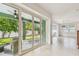 View of patio through sliding glass doors, connecting the indoors with outdoor seating at 511 Roanoke St, Dunedin, FL 34698