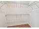 A walk-in closet with a hardwood floor and simple wire shelving for storage at 511 Roanoke St, Dunedin, FL 34698