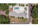 An aerial view shows the private backyard oasis with a pool and surrounding lush landscaping at 5201 108Th N St, St Petersburg, FL 33708