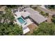 Aerial view of a home showcasing the pool, patio area, and lush surrounding landscape at 5201 108Th N St, St Petersburg, FL 33708