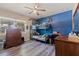 Vibrant bedroom with a bunk bed, hardwood floors, ceiling fan, dresser and plenty of natural light at 5201 108Th N St, St Petersburg, FL 33708