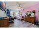 This bedroom features two beds, wood-look floors, and fun, colorful walls at 5201 108Th N St, St Petersburg, FL 33708
