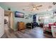 Bright bedroom with gray wood floors, ceiling fan and large TV, all painted with light blue walls at 5201 108Th N St, St Petersburg, FL 33708