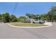 Well-manicured lawn and mature trees add curb appeal to this single-story home at 5201 108Th N St, St Petersburg, FL 33708
