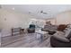 Spacious living room with hardwood floors, plush seating, and ample natural light at 5201 108Th N St, St Petersburg, FL 33708