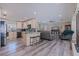 Open-concept kitchen and living area with wood flooring, modern appliances, and plenty of natural light at 5201 108Th N St, St Petersburg, FL 33708