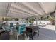 Undercover patio area includes BBQ grill and outdoor seating for entertaining near the pool at 5201 108Th N St, St Petersburg, FL 33708
