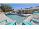 Backyard pool area featuring stylish blue chairs, a covered patio and refreshing clear water at 5201 108Th N St, St Petersburg, FL 33708