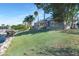 Waterfront backyard with lush lawn, dock and boat lift, and an enclosed pool with rock waterfall at 5225 Brighton Shore Dr, Apollo Beach, FL 33572