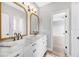 Bathroom with marble countertops, double sinks, framed mirrors and a doorway leading to a bedroom at 5225 Brighton Shore Dr, Apollo Beach, FL 33572