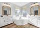 Dual sink bathroom with soaking tub and modern mirrors that offers a relaxing atmosphere at 5225 Brighton Shore Dr, Apollo Beach, FL 33572