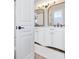 Bright bathroom features white cabinets, double sinks, and gold-framed mirrors over a light hardwood floor at 5225 Brighton Shore Dr, Apollo Beach, FL 33572