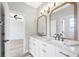 Modern bathroom featuring double sinks with marble countertops and decorative mirrors at 5225 Brighton Shore Dr, Apollo Beach, FL 33572