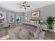 Serene bedroom features hardwood floors, natural light, and stylish modern furniture at 5225 Brighton Shore Dr, Apollo Beach, FL 33572