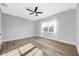 Bright bedroom with hardwood floors, ceiling fan, and large window at 5225 Brighton Shore Dr, Apollo Beach, FL 33572