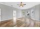 Open-concept bedroom showcasing hardwood floors, natural lighting, and access to the bathroom at 5225 Brighton Shore Dr, Apollo Beach, FL 33572