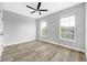 Bright bedroom with hardwood style floors and two windows overlooking greenery at 5225 Brighton Shore Dr, Apollo Beach, FL 33572