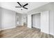 Spacious bedroom with hard wood style floors, ceiling fan, closet and bathroom access at 5225 Brighton Shore Dr, Apollo Beach, FL 33572