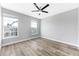Bright, empty bedroom with light hardwood floors, ceiling fan, and large windows at 5225 Brighton Shore Dr, Apollo Beach, FL 33572