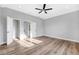 Large bedroom featuring wood look flooring and multiple doorways to the rest of the home at 5225 Brighton Shore Dr, Apollo Beach, FL 33572