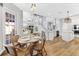 Bright dining area with modern lighting, hardwood floors, and open layout to the kitchen and staircase at 5225 Brighton Shore Dr, Apollo Beach, FL 33572