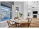 Cozy dining area with a view of the pool, seamlessly connected to the living room and fireplace area of the house at 5225 Brighton Shore Dr, Apollo Beach, FL 33572