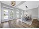 Bright dining room with a modern light fixture, ample windows, and double doors to backyard at 5225 Brighton Shore Dr, Apollo Beach, FL 33572