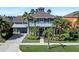 Beautiful two-story home featuring a well-manicured lawn with various palm trees and tasteful landscaping at 5225 Brighton Shore Dr, Apollo Beach, FL 33572