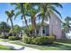 Charming two-story home showcasing a covered porch, vibrant landscaping, and a well-maintained lawn at 5225 Brighton Shore Dr, Apollo Beach, FL 33572