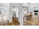 Hallway view of a bathroom and dining area with natural light and wood flooring at 5225 Brighton Shore Dr, Apollo Beach, FL 33572